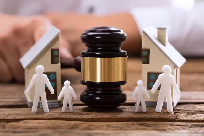Image of gavel dividing family and family.