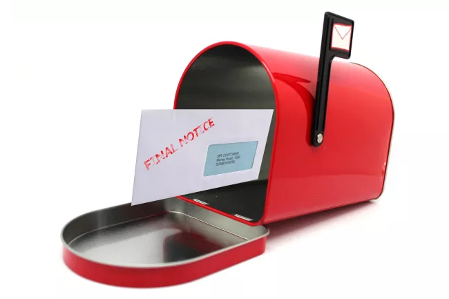 open red mailbox with letter showing final notice